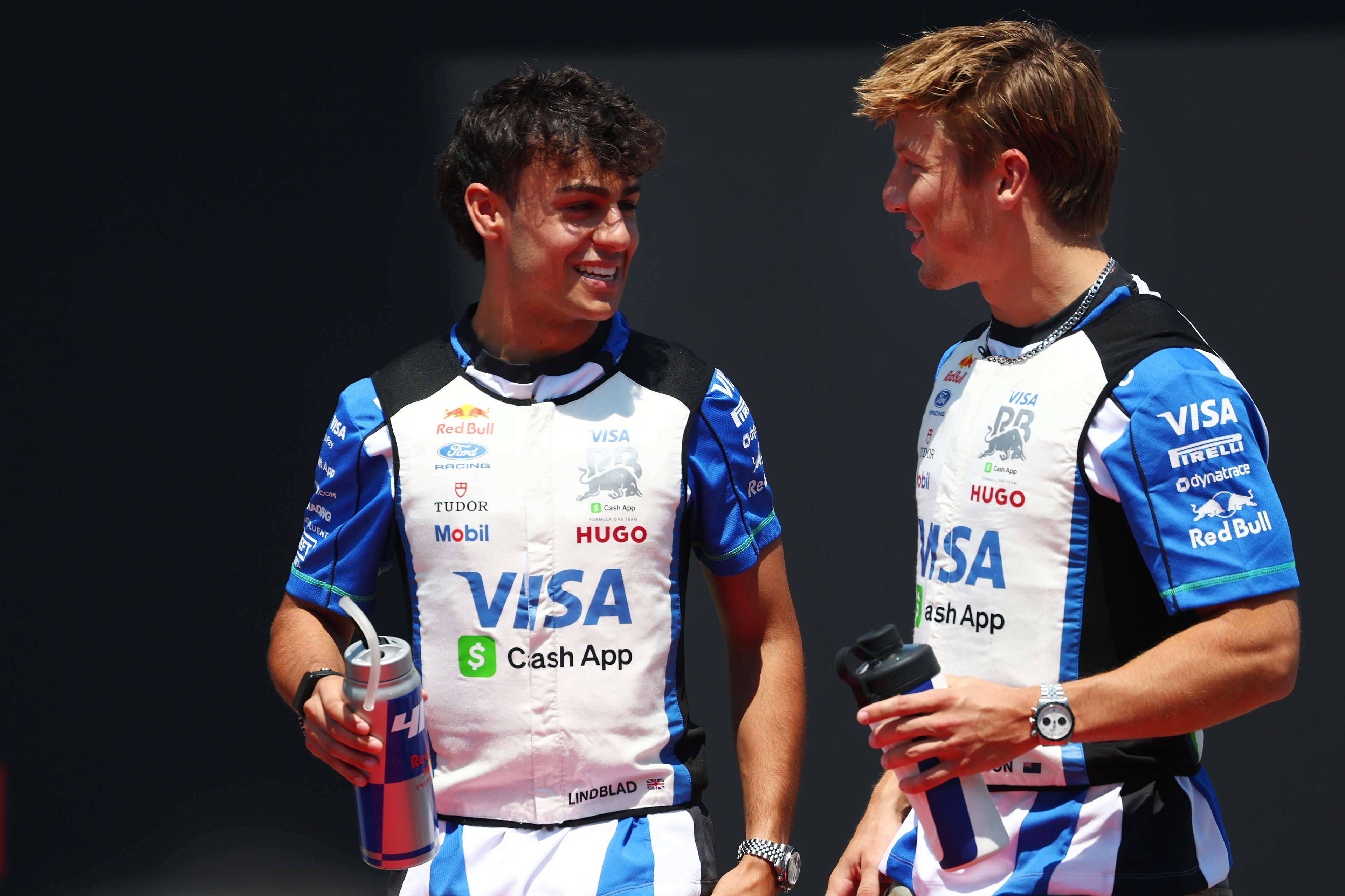 SPIELBERG, AUSTRIA - JUNE 28: Arvid Lindblad of Great Britain and Visa Cash App Racing Bulls and Liam Lawson of New Zealand and Visa Cash App Racing Bulls talk on the drivers parade prior to the F1 Grand Prix of Austria at Red Bull Ring on June 28, 2026 in Spielberg, Austria. (Photo by Sam Bloxham/LAT Images) // Getty Images / Red Bull Content Pool // SI202606280395 // Usage for editorial use only //